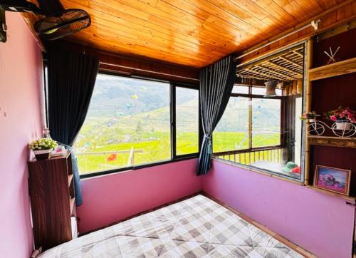 a room with a large window with a view at Terrace House Tả Van in Sa Pa