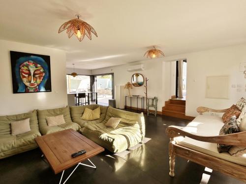 a living room with a couch and a table at Villa Ravenale in Grand Fond