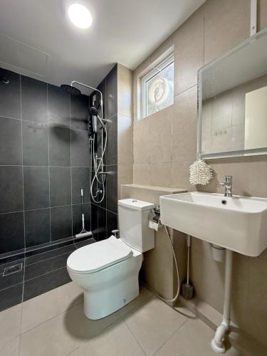 a bathroom with a toilet and a sink at Sri Indah The Eleventh 5pax in Sandakan