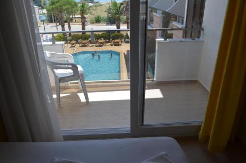 a view of a swimming pool from a hotel room window at Mulka Hotel in Ayvalık