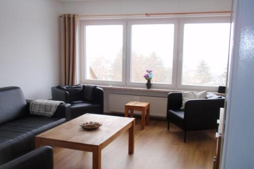 a living room with a couch and chairs and a table at Villa Hochwald Familienhaus in Geisfeld