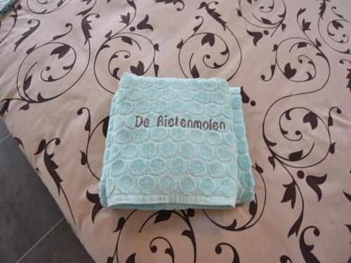 a towel sitting on a bed with a wall at Holiday Home in Alveringem near Beach in Alveringem
