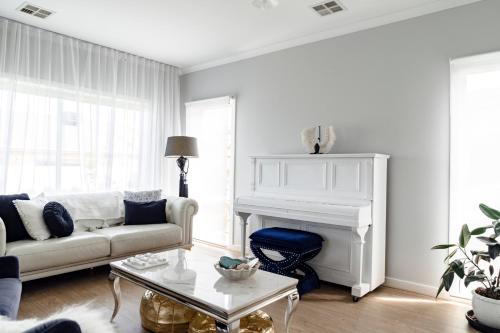 a living room with a couch and a fireplace at Spacious Hamptons-style home with plunge pool in Saint Leonards
