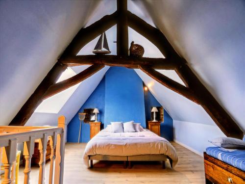 a bedroom with a bed in an attic at Montaigu Countryside Stay in Montaigu-les-Bois