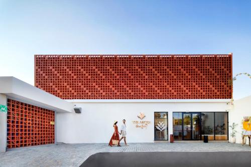 two women walking in front of a building at The Arden Villa Uluwatu by Ini Vie Hospitality in Uluwatu