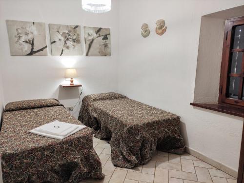 a room with two beds and a table in it at Villa in Sasso Pisano wuith garden in Sasso Pisano