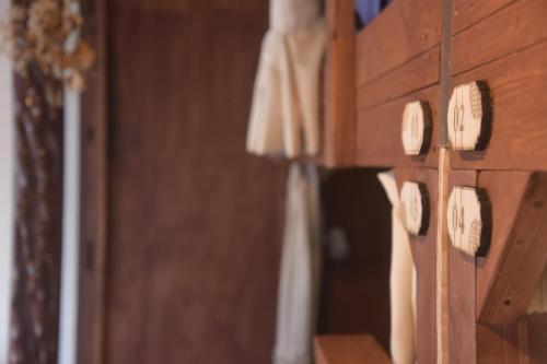 a row of dresses hanging on a wooden wall at 海好きな大人の隠れ家下田ハウス in Shimoda