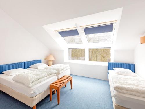 a bedroom with two beds and a window at Pet-Friendly Escape in Fauvillers in Fauvillers
