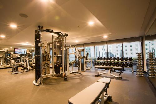 a gym with a lot of equipment in a room at Pullman Sydney Airport in Sydney