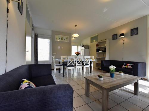 a living room with a couch and a table at Holiday Home in Lochem near Forest Trails in Lochem