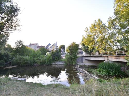 a bridge over a river with its reflection in the water at Villa with Spa & Pool in Villiers-les-Moines