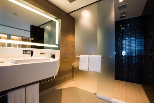 a bathroom with a sink and a mirror at Pullman Sydney Airport in Sydney