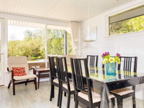 a dining room with a glass table and chairs at 4 star holiday home in Fur in Fur