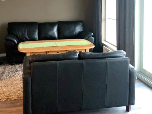 a black couch with a table on top of it at 6 person holiday home in Kverva in Dyrvik