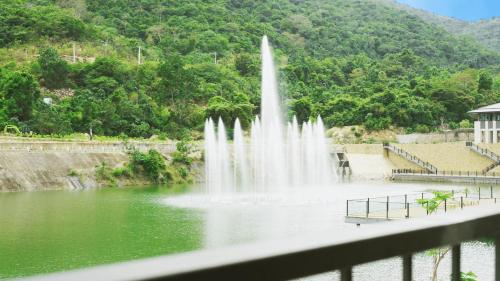 a fountain in the middle of a body of water at Swiss-Belvillas Solavita Binh Tien in Binh Tien
