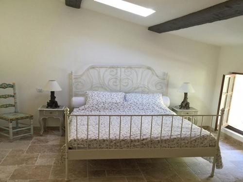 a bedroom with a bed and two tables and a chair at Villa in Ampus with Panoramic Views & Pool in Ampus