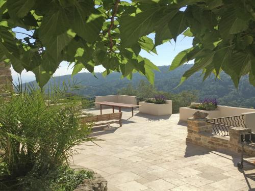 a patio with a picnic table and a view of the mountains at Villa in Ampus with Panoramic Views & Pool in Ampus
