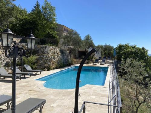 a swimming pool with a light pole next to it at Villa in Ampus with Panoramic Views & Pool in Ampus