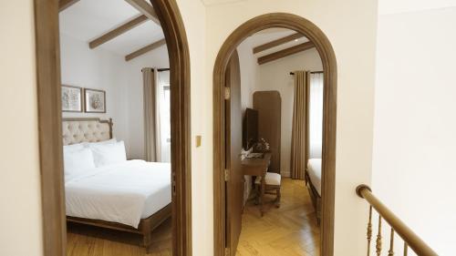 a bedroom with a bed and a mirror at Swiss-Belvillas Solavita Binh Tien in Binh Tien