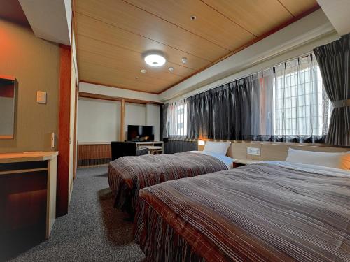 Una cama o camas en una habitación de Ark Hotel Okayama -ROUTE INN HOTELS-