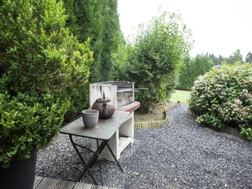 a table with a tea pot on it in a garden at Luxury Wellness Villa, Septon in Durbuy