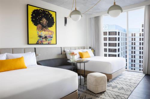 a hotel room with two beds and a table at Hyatt Centric Congress Avenue Austin in Austin