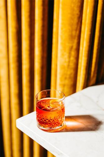 a glass of tea sitting on top of a table at Hyatt Centric Congress Avenue Austin in Austin