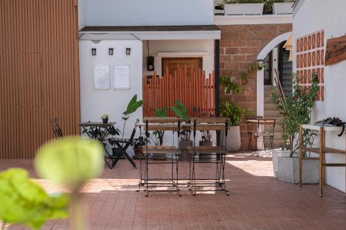 a patio with chairs and a table with birds on it at Baan Old Town Boutique Stay, Phuket Town in Phuket