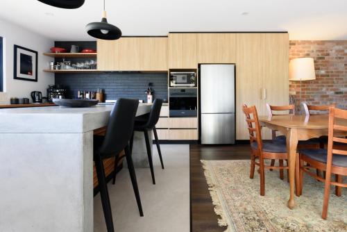 a kitchen and dining room with a table and chairs at Cosy Getaway with outdoor spaces in Launceston