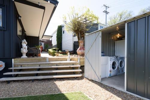 a house with a washer and dryer in a yard at Cosy Getaway with outdoor spaces in Launceston