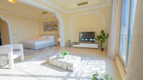 a bedroom with a bed and a living room at The Grand Hamra Stay by Hala Holiday Homes in Ras al Khaimah