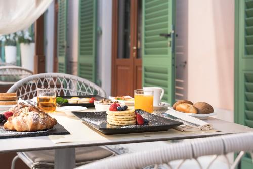 a table with breakfast foods and drinks on it at Hotel Ercolini & Savi in Montecatini Terme
