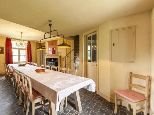 a dining room with a long table and chairs at Beernem Farmhouse with Pool in Beernem