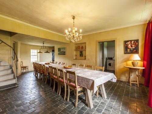 a dining room with a long table and chairs at Beernem Farmhouse with Pool in Beernem