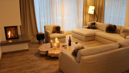 a living room filled with furniture and a fireplace at Adler Resort in Saalbach-Hinterglemm