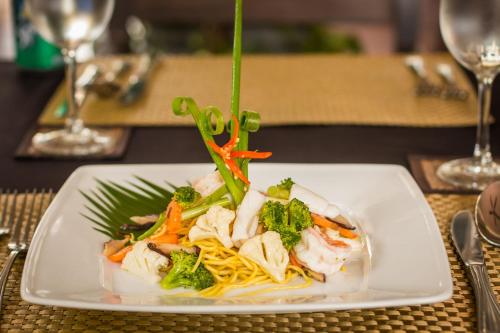 a plate of food with shrimp and noodles on a table at SAKABAN Suite in Siem Reap