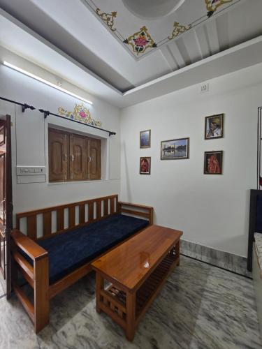 a bedroom with a bed and a table in a room at little Princess Guest House in Bikaner