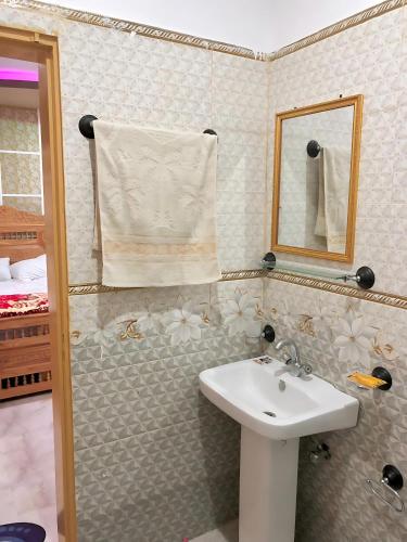 a bathroom with a sink and a mirror at Eagle Resort Hotel and Restaurant in Naran