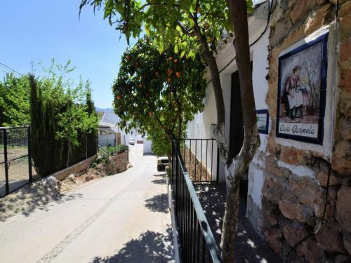 a tree next to a building with a sign on it at Holiday Home in Zagrilla Alta with Pool in Zagrilla