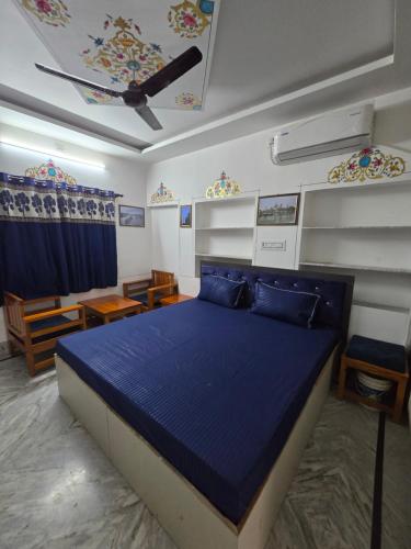 a bedroom with a blue bed in a room at little Princess Guest House in Bikaner
