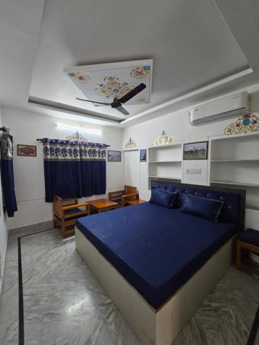 a bedroom with a blue bed in a room at little Princess Guest House in Bikaner