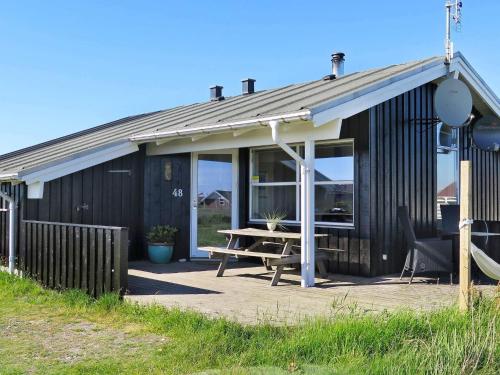 a building with a picnic table in front of it at 6 person holiday home in Lemvig-By Traum in Trans