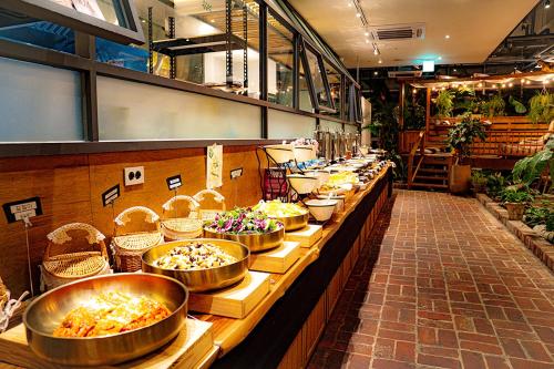 a buffet line with lots of bowls of food at Staz Hotel Premier Dongtan in Hwaseong