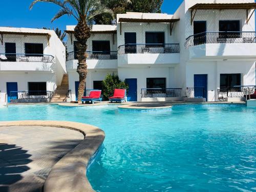 a swimming pool in front of a building at New Sphinx Resort in Dahab
