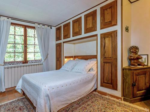 a bedroom with a bed and a large window at Holiday Home in Le Luc with Pool & Vineyards in Le Luc