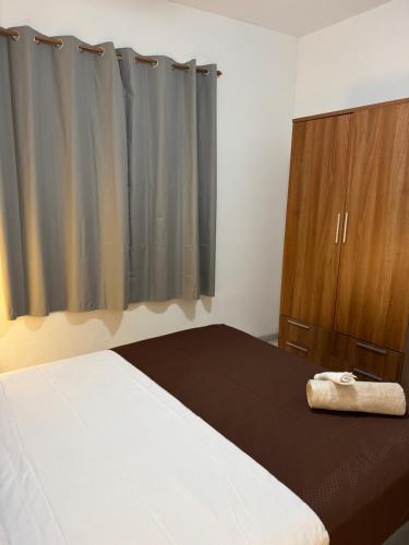 a bedroom with a bed and a wooden cabinet at Casona Los Sidoros Ciudad de Berja in Berja