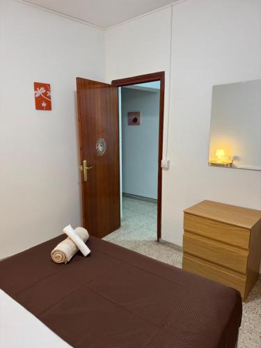 a bedroom with a bed and a door to a hallway at Casona Los Sidoros Ciudad de Berja in Berja