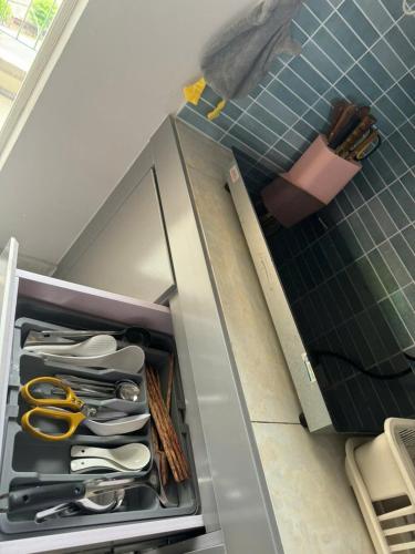a drawer filled with utensils in a kitchen at Peach Peach Home 2 in Ấp Mỹ Hòa