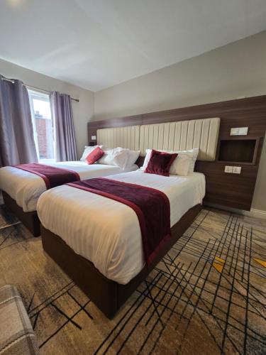 a hotel room with two beds in a room at Double bedroom studios in Dublin