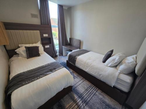 a hotel room with two beds and a window at Double bedroom studios in Dublin